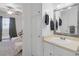 Bright bathroom with a decorative mirror and built in linen closet next to an adjacent bedroom at 526 Sellers Pl, Henderson, NV 89011