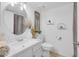 A bathroom features a round mirror, white vanity, and decorative accessories at 526 Sellers Pl, Henderson, NV 89011