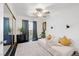 Cozy bedroom featuring a comfortable daybed, mirrored closet and a sliding glass door to the balcony at 526 Sellers Pl, Henderson, NV 89011