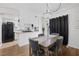 A dining area features a chandelier, wood table, padded chairs and dark curtains at 526 Sellers Pl, Henderson, NV 89011