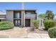 Condo exterior featuring stucco walls, chimney, small balcony, and desert landscaping at 526 Sellers Pl, Henderson, NV 89011