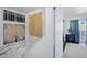 Bright hallway with decorative artwork near a bedroom with a plant and mirrored closet at 526 Sellers Pl, Henderson, NV 89011