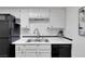 A modern kitchen with stainless steel appliances, white cabinets, and white countertop at 526 Sellers Pl, Henderson, NV 89011