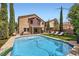 A backyard featuring a pool, hot tub, outdoor kitchen and seating area at 529 Caribbean Palm Dr, Las Vegas, NV 89138