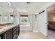 Bright bathroom featuring double vanity, soaking tub, and separate shower at 529 Caribbean Palm Dr, Las Vegas, NV 89138