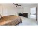 Bright bedroom featuring ceiling fan, neutral carpet, and generous closet space at 529 Caribbean Palm Dr, Las Vegas, NV 89138