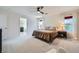 Spacious bedroom with large windows, neutral carpet, and ceiling fan at 529 Caribbean Palm Dr, Las Vegas, NV 89138
