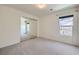 A bright bedroom with neutral walls, carpet, window and closet with mirrored doors at 529 Caribbean Palm Dr, Las Vegas, NV 89138