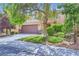 Two-story home with a two-car garage and a charming, well-maintained front yard at 529 Caribbean Palm Dr, Las Vegas, NV 89138