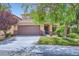 Charming two-story home featuring a well-manicured lawn, covered entrance, and a two-car garage at 529 Caribbean Palm Dr, Las Vegas, NV 89138