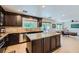 Spacious kitchen boasts dark cabinets, granite counters, stainless appliances, and an island at 529 Caribbean Palm Dr, Las Vegas, NV 89138