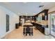Open kitchen with dark cabinetry, granite countertops, stainless appliances, and a central island at 529 Caribbean Palm Dr, Las Vegas, NV 89138