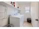 A laundry room featuring white washer and dryer and shelving at 529 Caribbean Palm Dr, Las Vegas, NV 89138