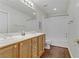 Bright bathroom features double sinks, a wood cabinet, and a shower/tub combo with curtain at 5465 Cardinal Ridge Ct # 103, Las Vegas, NV 89149