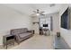 Comfortable bedroom with a sofa, desk, and ceiling fan, ideal for relaxation and productivity at 5465 Cardinal Ridge Ct # 103, Las Vegas, NV 89149