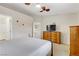 Spacious bedroom featuring a bed, dresser, and tv at 5465 Cardinal Ridge Ct # 103, Las Vegas, NV 89149