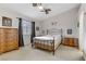 Serene bedroom with a metal frame bed, dresser, and ample natural light from the window at 5465 Cardinal Ridge Ct # 103, Las Vegas, NV 89149