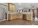Open-concept kitchen featuring wooden cabinetry, stainless steel appliances, and an adjacent dining area at 5465 Cardinal Ridge Ct # 103, Las Vegas, NV 89149