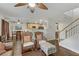 Inviting living room featuring hardwood floors and charming wicker chairs, seamlessly flowing into the kitchen at 5465 Cardinal Ridge Ct # 103, Las Vegas, NV 89149