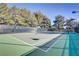 Well-maintained outdoor tennis court surrounded by mature trees at 5465 Cardinal Ridge Ct # 103, Las Vegas, NV 89149