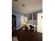 Well-lit bedroom with dark wood floors, desk, and creative decor at 5576 W Rochelle Ave # 13A, Las Vegas, NV 89103