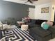 Spacious living room featuring a large sectional sofa, stylish rug, and trendy decorations at 5576 W Rochelle Ave # 13A, Las Vegas, NV 89103