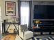 Living room view with modern decor, including gray accent wall and entertainment center at 5576 W Rochelle Ave # 13A, Las Vegas, NV 89103