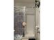 Shower with white tile and patterned glass door, adding a stylish touch at 5576 W Rochelle Ave # 13A, Las Vegas, NV 89103