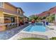 Backyard pool with a waterfall, spa, covered patio and well-manicured landscaping at 5635 Mesa Mountain Dr, Las Vegas, NV 89135