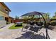 Backyard featuring a shady swing and a ping pong table set in a paved patio at 5635 Mesa Mountain Dr, Las Vegas, NV 89135