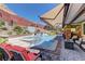 Backyard pool with a waterfall, spa, covered patio and well-manicured landscaping at 5635 Mesa Mountain Dr, Las Vegas, NV 89135