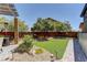 This backyard features a cozy patio, artificial grass, and beautiful landscaping at 5635 Mesa Mountain Dr, Las Vegas, NV 89135