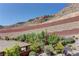 Landscaped backyard with trees, patio seating, and privacy from the mountain at 5635 Mesa Mountain Dr, Las Vegas, NV 89135