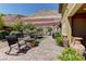 Backyard patio with comfortable seating, fire pit, and views of desert landscaping at 5635 Mesa Mountain Dr, Las Vegas, NV 89135