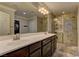 Well-appointed bathroom with double sinks, a large mirror, and glass shower enclosure at 5635 Mesa Mountain Dr, Las Vegas, NV 89135