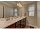 Bathroom featuring double sinks, bright vanity lighting, and framed mirrors at 5635 Mesa Mountain Dr, Las Vegas, NV 89135