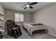 Cozy bedroom featuring soft carpet, natural light, and a modern ceiling fan at 5635 Mesa Mountain Dr, Las Vegas, NV 89135