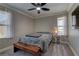 Comfortable bedroom with ceiling fan, bright windows, and cozy decor at 5635 Mesa Mountain Dr, Las Vegas, NV 89135