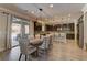 Open dining area features modern lighting, access to the backyard, and flows into the kitchen at 5635 Mesa Mountain Dr, Las Vegas, NV 89135