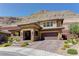 Attractive two-story home features desert landscaping and a mountain backdrop with a three-car garage at 5635 Mesa Mountain Dr, Las Vegas, NV 89135