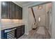 Welcoming foyer featuring a beverage center, and a staircase leading to the upper level at 5635 Mesa Mountain Dr, Las Vegas, NV 89135