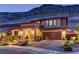 Attractive two-story house featuring stone accents and a lush front yard landscaping, perfectly complementing the hillside setting at 5635 Mesa Mountain Dr, Las Vegas, NV 89135