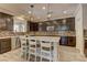 Modern kitchen boasts an island with seating, stainless steel appliances, and sleek countertops at 5635 Mesa Mountain Dr, Las Vegas, NV 89135