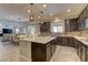 Bright, open kitchen featuring dark cabinets, a center island, and stainless steel appliances at 5635 Mesa Mountain Dr, Las Vegas, NV 89135