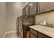 Functional laundry room with a sink, washer, dryer, and built-in storage cabinets at 5635 Mesa Mountain Dr, Las Vegas, NV 89135