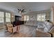 Spacious living room with a ceiling fan and a comfortable sectional, brightened by natural light at 5635 Mesa Mountain Dr, Las Vegas, NV 89135