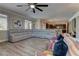 Spacious living room features a large sectional sofa, wood flooring, and a ceiling fan at 5635 Mesa Mountain Dr, Las Vegas, NV 89135