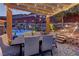 Elegant outdoor dining area under a pergola with a view of the pool and beautifully landscaped backyard at 5635 Mesa Mountain Dr, Las Vegas, NV 89135