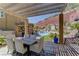 A stylish outdoor dining area with a pool, pergola, and mountain views at 5635 Mesa Mountain Dr, Las Vegas, NV 89135