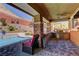 A covered outdoor kitchen with a built-in grill overlooks the beautiful swimming pool at 5635 Mesa Mountain Dr, Las Vegas, NV 89135